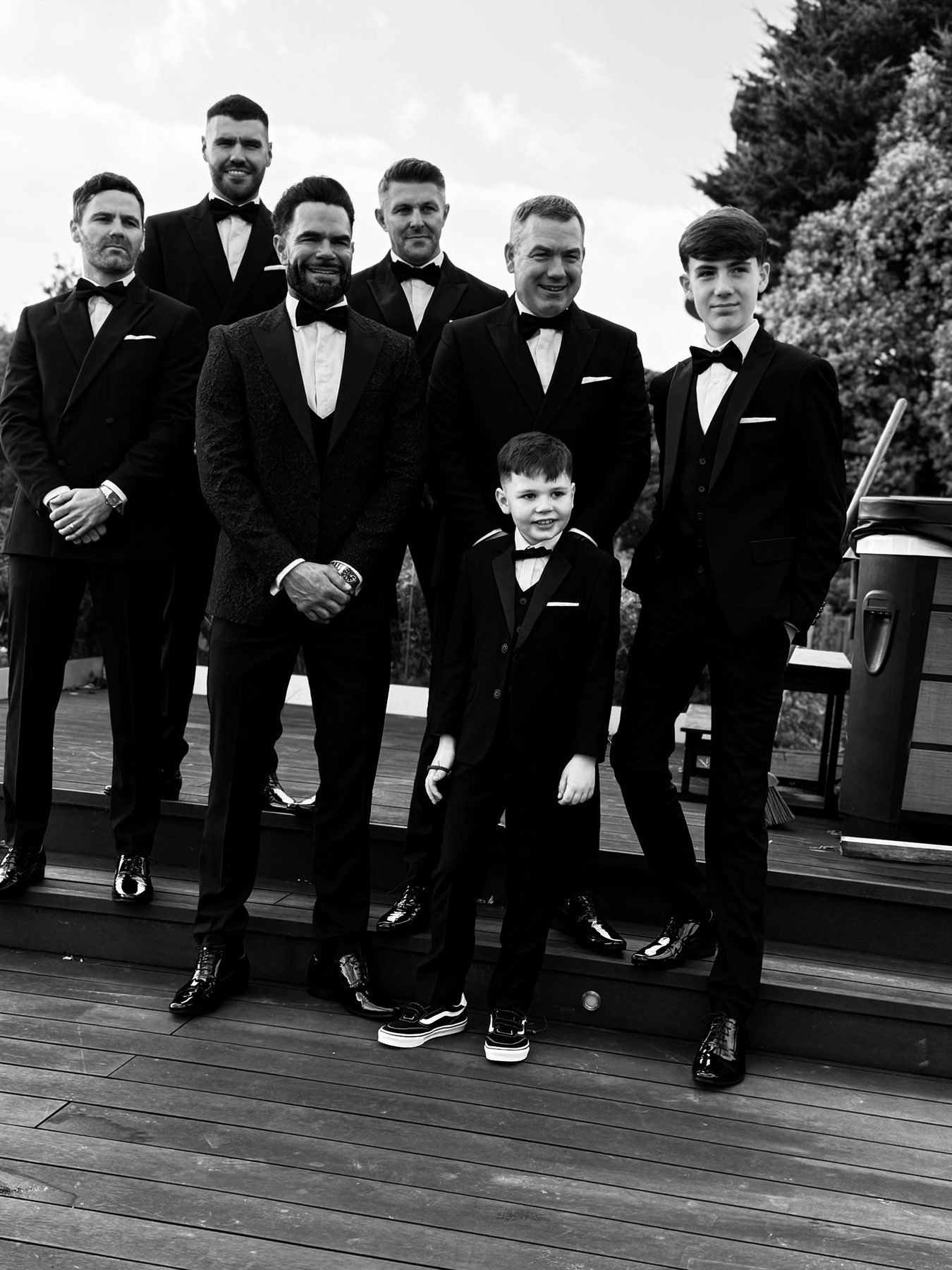 The full wedding party, including a page boy, on the decking before leaving.
